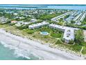 Aerial view of beachfront property with pool and lush landscaping at 5757 Gulf Of Mexico Dr # 109, Longboat Key, FL 34228