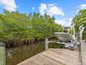 Private dock with boat lift, offering quick access to the water at 705 Jungle Queen Way, Longboat Key, FL 34228