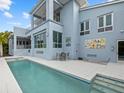 Inviting heated pool with expansive patio and water views at 705 Jungle Queen Way, Longboat Key, FL 34228