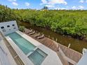 Relaxing pool and spa area overlooking a peaceful waterway at 705 Jungle Queen Way, Longboat Key, FL 34228