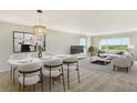 Living room with dining area, featuring light carpeting and modern furniture at 4540 Gulf Of Mexico Dr # Ph1, Longboat Key, FL 34228