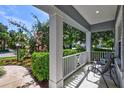 Front porch with white columns, railing, and seating at 16848 Rosedown Gln, Parrish, FL 34219