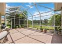 Spacious screened-in patio with brick flooring and views of the pond at 432 Snapdragon Loop, Bradenton, FL 34212