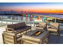 Relaxing rooftop terrace with fire pit and seating at 111 Golden Gate Pt # 201, Sarasota, FL 34236