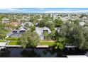 Aerial view of waterfront property with private dock and lush landscaping at 4532 Shark Dr, Bradenton, FL 34208