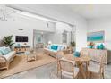 Open living space with seating area and dining table at 1520 Pelican Point Dr # 251, Sarasota, FL 34231