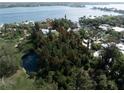 Large waterfront lot with mature landscaping at 7401-B Midnight Pass Rd, Sarasota, FL 34242