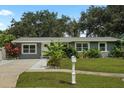 Gray house with a well-manicured lawn and walkway at 4695 86Th N Ave, Pinellas Park, FL 33782