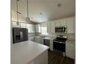 Modern kitchen featuring stainless steel appliances and an island at 1702 Rada Ln, North Port, FL 34288