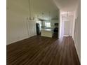 Open living area with hardwood floors and access to the kitchen at 1702 Rada Ln, North Port, FL 34288