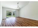 Bright living room with wood-look floors and sliding glass doors leading to the backyard at 1702 Rada Ln, North Port, FL 34288