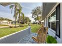 Relaxing front porch view of the neighborhood featuring mature landscaping, palm trees, and lush green lawns at 2806 67Th W St, Bradenton, FL 34209