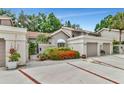 Two-story townhome with attached garage and lush landscaping at 4540 Ascot N Cir, Sarasota, FL 34235