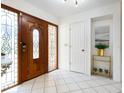 Bright entryway with wood door and tile floors at 5050 Kestral Park S Way, Sarasota, FL 34231