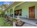 Inviting front porch with a view of the nicely landscaped yard at 2403 Palma Sola Blvd, Bradenton, FL 34209