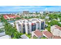 Aerial view showcasing condo building, pool, and surrounding area at 6157 Midnight Pass Rd # E65, Sarasota, FL 34242