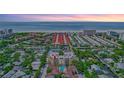 Condo building's aerial view, highlighting its location near the beach at 6157 Midnight Pass Rd # E65, Sarasota, FL 34242