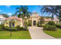 Luxury home with lush landscaping and a circular driveway at 7203 Chatsworth Ct, University Park, FL 34201