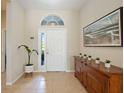 Bright and airy entryway with a wooden console table and large artwork at 11410 Griffith Park Ter, Bradenton, FL 34211