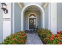 Inviting home exterior with a charming walkway and lush landscaping at 11410 Griffith Park Ter, Bradenton, FL 34211