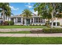 One-story home with teal front door and lush landscaping at 302 Americas Cup Blvd, Bradenton, FL 34208