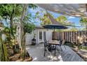 Backyard with deck, table, chairs, and shade sail at 4020 School S Ave, Sarasota, FL 34231