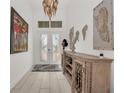 Bright and spacious entryway with elegant chandelier and console table at 17745 Lucaya Dr, Lakewood Ranch, FL 34202