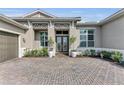 Inviting entryway with double doors and manicured landscaping at 17745 Lucaya Dr, Lakewood Ranch, FL 34202