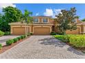 Three-car garage townhome; brick paver driveway, manicured landscaping at 323 Winding Brook Ln # 102, Bradenton, FL 34212