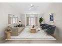 Living room with double doors leading outside, tastefully staged with modern furniture and decor at 8993 Bantry Bay Blvd, Englewood, FL 34224