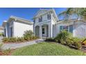 Two-story house with gray and white walls, gray roof, and landscaping at 21285 Holmes Cir, Venice, FL 34293