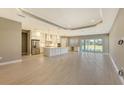 Open concept kitchen with white cabinets, large island, and stainless steel appliances at 21285 Holmes Cir, Venice, FL 34293