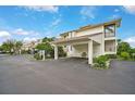 Exterior view of condo building with parking and landscaping at 1026 Bird Bay Way # 276, Venice, FL 34285