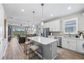 Spacious kitchen with island, white cabinets, and stainless steel appliances at 10646 Spring Tide Way, Parrish, FL 34219