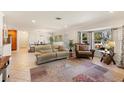 Bright living room with tile floors, a bay window, and comfortable seating arrangement at 2522 Fruit Tree Dr, Sarasota, FL 34239