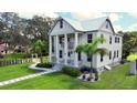 Two-story house with a white exterior, columned porch, and landscaped yard at 3101 Riverview Blvd, Bradenton, FL 34205