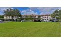 Condo building with covered parking and lush green lawn at 6503 Stone River Rd # 302, Bradenton, FL 34203