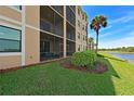 Ground level patio with screened enclosure, overlooking a pond and golf course at 6515 Grand Estuary Trl # 105, Bradenton, FL 34212