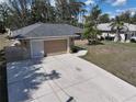 Well-kept single-story home with attached garage and spacious concrete driveway at 4337 Mermell Cir, North Port, FL 34291