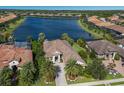 Luxury home with lake view and lush landscaping in a gated community at 7216 Prestbury Cir, Lakewood Ranch, FL 34202