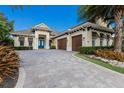 Beautiful home with three car garage, nice landscaping, and unique stone paver driveway at 7216 Prestbury Cir, Lakewood Ranch, FL 34202