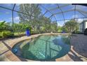Relaxing kidney-shaped pool with a screened enclosure at 1362 Hedgewood Cir, North Port, FL 34288