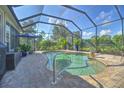 Screened-in pool and spa with brick pavers at 1362 Hedgewood Cir, North Port, FL 34288