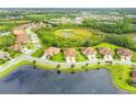 Aerial view showcases home's location in a community by a lake at 212 Casalino Dr, Nokomis, FL 34275