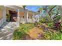Inviting front entrance with stairs, porch, and well-maintained landscaping at 5309 Hidden Harbor Rd, Sarasota, FL 34242