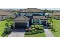 Two-story home with tile roof, paver driveway and neatly landscaped yard at 14118 Florida Rosemary Dr, Bradenton, FL 34211