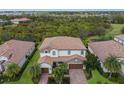 Luxury home with tile roof, two-car garage, and lush landscaping at 13107 Belknap Pl, Lakewood Ranch, FL 34211