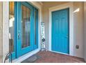 Modern front entry featuring double blue doors and a welcome sign at 5130 Tidewater Preserve Blvd, Bradenton, FL 34208
