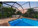 Relaxing screened pool and patio area with seating at 6895 Willowshire Way, Bradenton, FL 34212