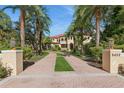 Grand two-story home with palm trees and brick driveway at 9452 Swaying Branch Rd, Sarasota, FL 34241